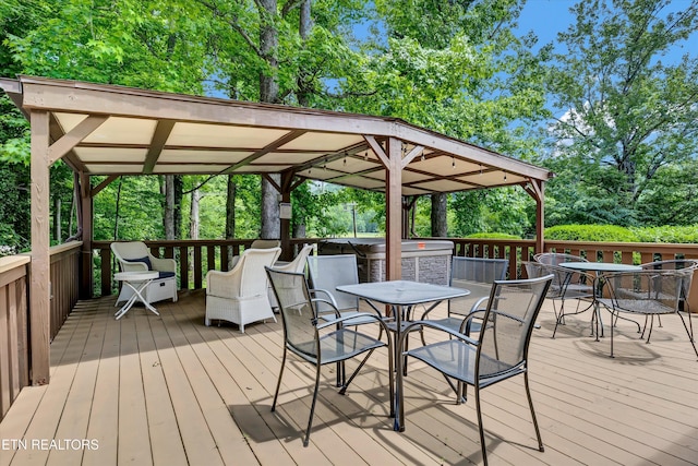 3950 Castle Rd, Gatlinburg, TN 37738 - wooden terrace with outdoor dining area, a gazebo, and view of scattered trees