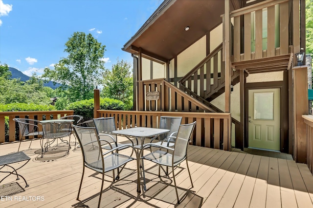 3950 Castle Rd, Gatlinburg, TN 37738 - wooden terrace with outdoor dining space, stairs, and a mountain view