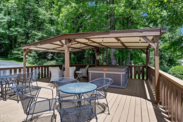 3950 Castle Rd, Gatlinburg, TN 37738 - wooden deck with outdoor dining space, a gazebo, a hot tub, and view of scattered trees