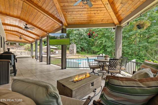 203 Georgian Ln, Sevierville, TN 37862 - view of patio / terrace featuring ceiling fan, a fire pit, an outdoor pool, and outdoor dining area