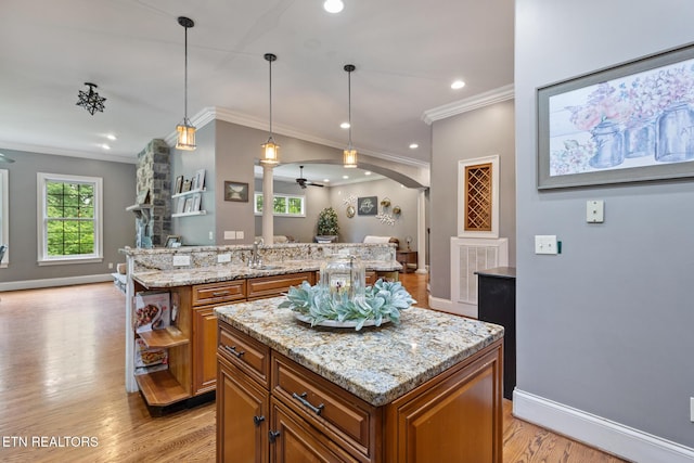203 Georgian Ln, Sevierville, TN 37862 - kitchen featuring a kitchen island, brown cabinets, open shelves, crown molding, and open floor plan