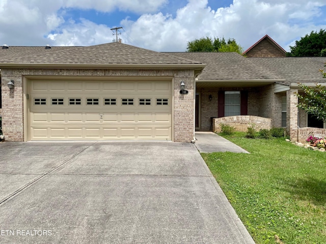 209 Commander Way, Knoxville, TN 37934 - view of front facade with driveway, brick siding, roof with shingles, a front yard, and a garage