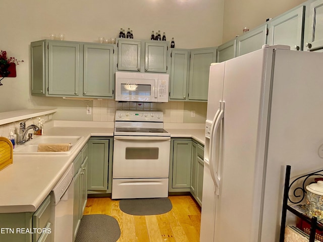 209 Commander Way, Knoxville, TN 37934 - kitchen featuring white appliances, green cabinets, light wood-type flooring, light countertops, and decorative backsplash