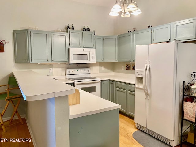 209 Commander Way, Knoxville, TN 37934 - kitchen with white appliances, a peninsula, light wood-style flooring, and light countertops