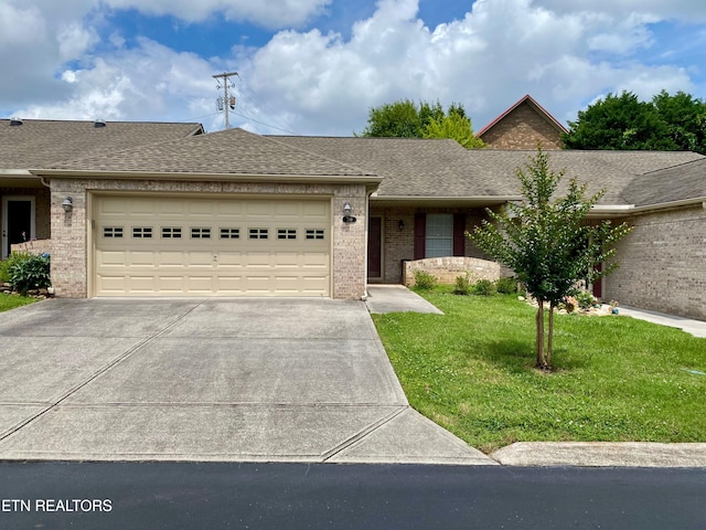 209 Commander Way, Knoxville, TN 37934 - ranch-style home with concrete driveway, an attached garage, brick siding, a front lawn, and roof with shingles