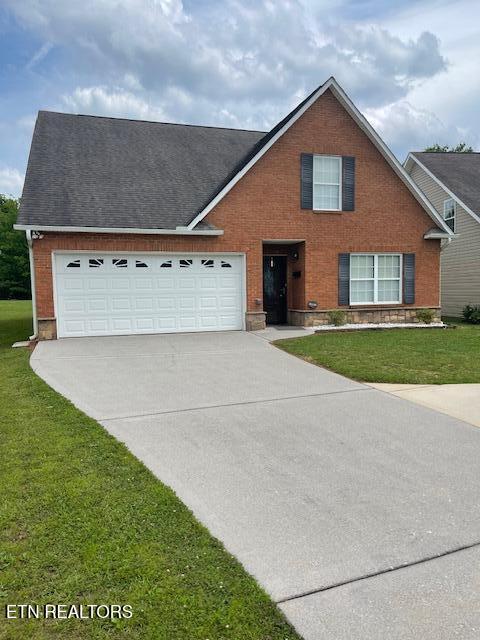109 Abbott Rd, Lenoir City, TN 37771 - traditional home with driveway, brick siding, and a front yard