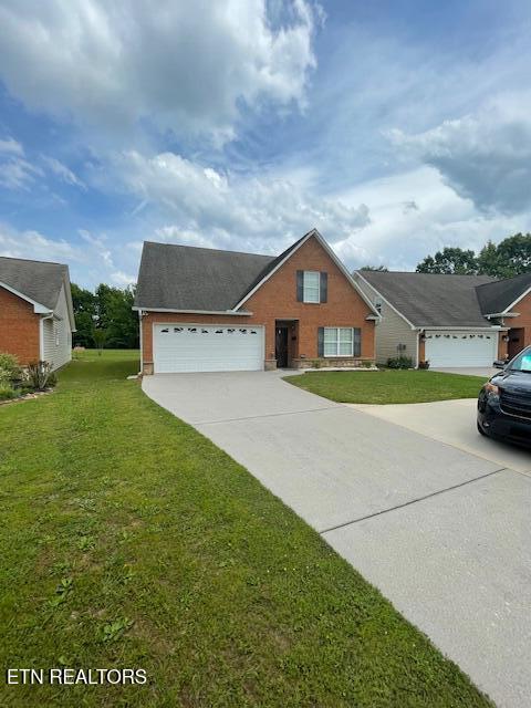 109 Abbott Rd, Lenoir City, TN 37771 - traditional-style home featuring concrete driveway, an attached garage, and a front yard