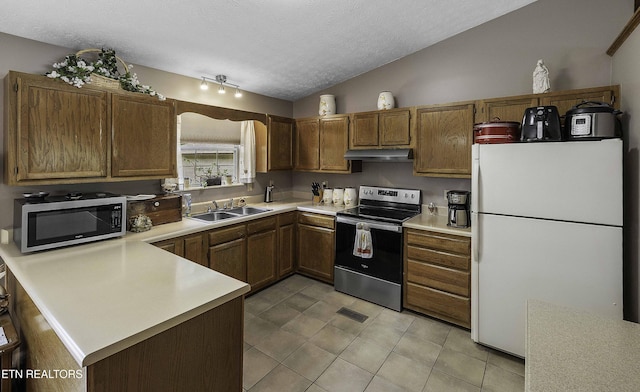 113 Skyland Ln, Powell, TN 37849 - kitchen with appliances with stainless steel finishes, lofted ceiling, under cabinet range hood, a textured ceiling, and light tile patterned floors