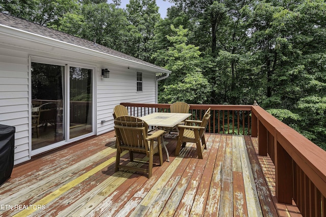113 Skyland Ln, Powell, TN 37849 - wooden terrace featuring outdoor dining space and view of wooded area