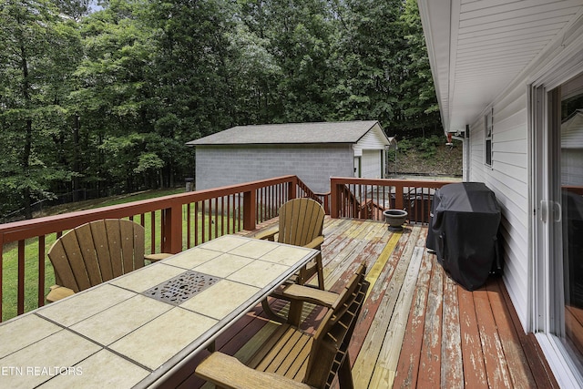 113 Skyland Ln, Powell, TN 37849 - wooden deck featuring outdoor dining space, grilling area, and an outdoor structure