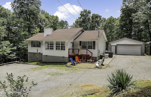 113 Skyland Ln, Powell, TN 37849 - view of front of house featuring an outbuilding, crawl space, a detached garage, a chimney, and view of wooded area