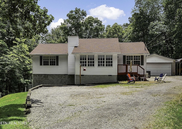 113 Skyland Ln, Powell, TN 37849 - view of front of home with crawl space, a chimney, a detached garage, and view of wooded area