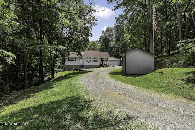 113 Skyland Ln, Powell, TN 37849 - view of front of home featuring a storage unit, driveway, a front lawn, and a garage