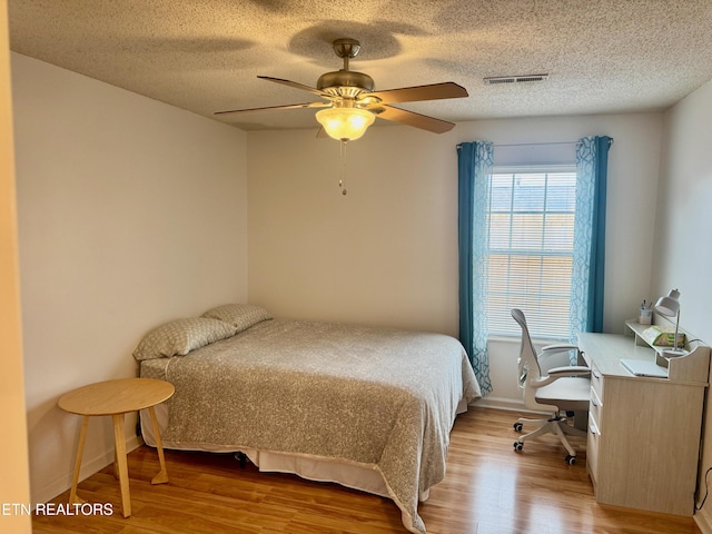 7925 Eldin Way, Powell, TN 37849 - bedroom featuring wood finished floors, a desk, a textured ceiling, and a ceiling fan
