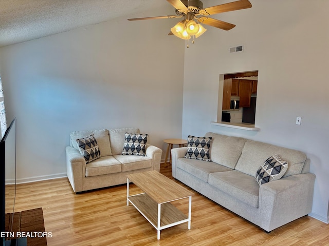 7925 Eldin Way, Powell, TN 37849 - living room with light wood-style flooring, high vaulted ceiling, and a ceiling fan