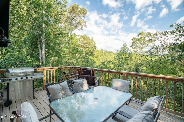 1065 Shell Mountain Rd, Sevierville, TN 37876 - wooden terrace featuring outdoor dining space, grilling area, and a wooded view