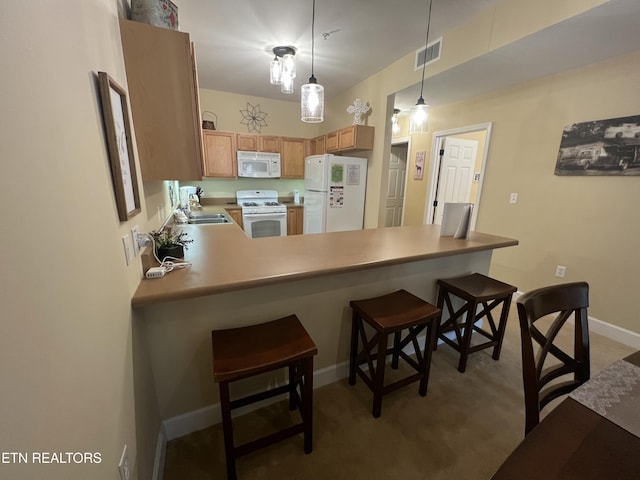 527 River Place Way Unit 516, Sevierville, TN 37862 - kitchen featuring white appliances, a peninsula, hanging light fixtures, a breakfast bar area, and light colored carpet