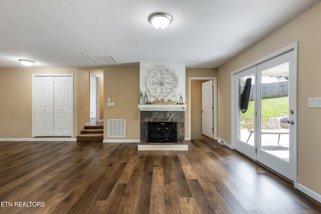 4313 Midview Ln, Knoxville, TN 37938 - unfurnished living room featuring dark wood-style floors, a tile fireplace, and stairs