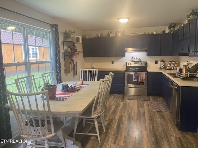 1843 Tazewell Pike, Corryton, TN 37721 - kitchen with stainless steel appliances, under cabinet range hood, dark wood-type flooring, light countertops, and dark cabinets
