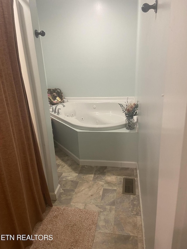 1843 Tazewell Pike, Corryton, TN 37721 - full bathroom with a tub with jets and stone finish flooring