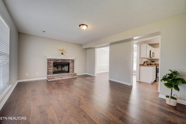 4004 Abercorn Rd, Knoxville, TN 37921 - unfurnished living room featuring wood finished floors, healthy amount of natural light, and a fireplace