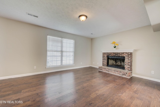 4004 Abercorn Rd, Knoxville, TN 37921 - unfurnished living room with wood finished floors, a fireplace, and a textured ceiling