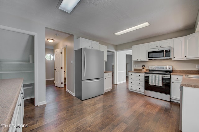 4004 Abercorn Rd, Knoxville, TN 37921 - kitchen with stainless steel appliances, dark wood-type flooring, white cabinets, and a textured ceiling