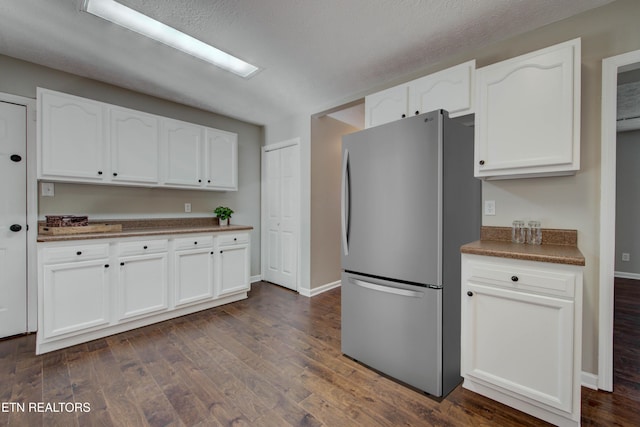 4004 Abercorn Rd, Knoxville, TN 37921 - kitchen with freestanding refrigerator, white cabinetry, dark wood-type flooring, and dark countertops