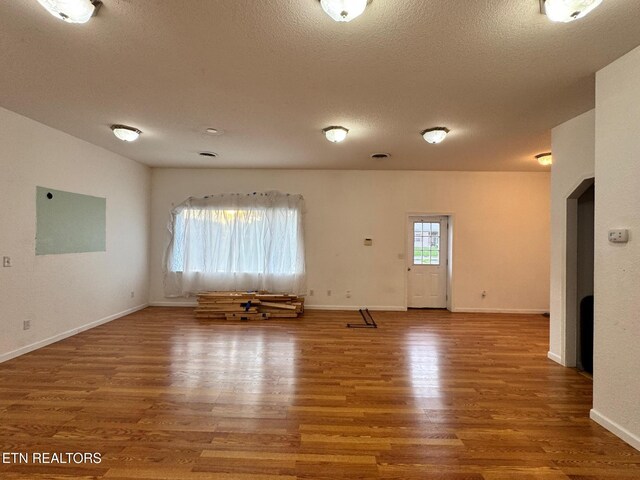 5521 S York Hwy, Grimsley, TN 38565 - empty room with wood finished floors and a textured ceiling