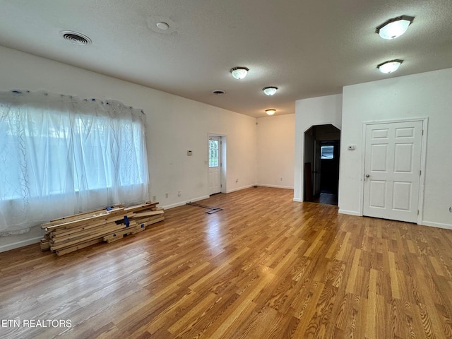 5521 S York Hwy, Grimsley, TN 38565 - unfurnished living room with light wood-type flooring and a textured ceiling