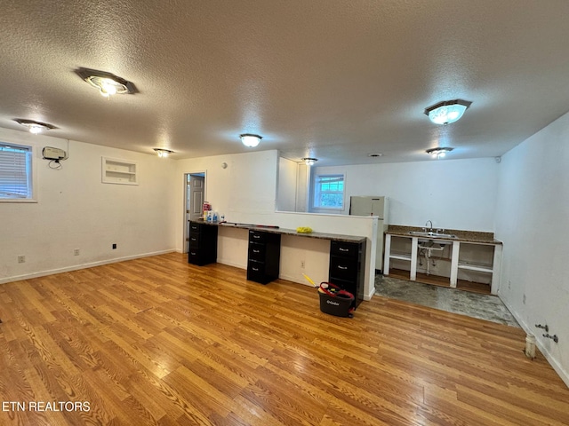 5521 S York Hwy, Grimsley, TN 38565 - basement featuring a textured ceiling, light wood finished floors, and freestanding refrigerator