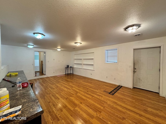 5521 S York Hwy, Grimsley, TN 38565 - basement with a textured ceiling, wood finished floors, and built in features