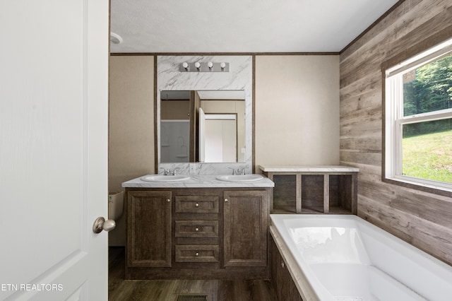 750 Bethlehem Rd, Lafollette, TN 37766 - full bath featuring wooden walls, a garden tub, double vanity, ornamental molding, and wood finished floors