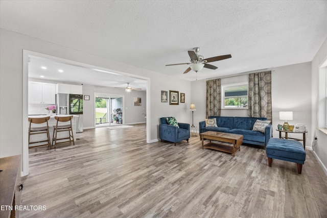 3408 Hackberry Rd, Knoxville, TN 37931 - living area featuring light wood-style flooring, a ceiling fan, and a textured ceiling