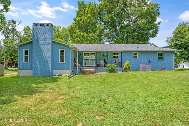 3408 Hackberry Rd, Knoxville, TN 37931 - rear view of house featuring a lawn, a chimney, a porch, and board and batten siding