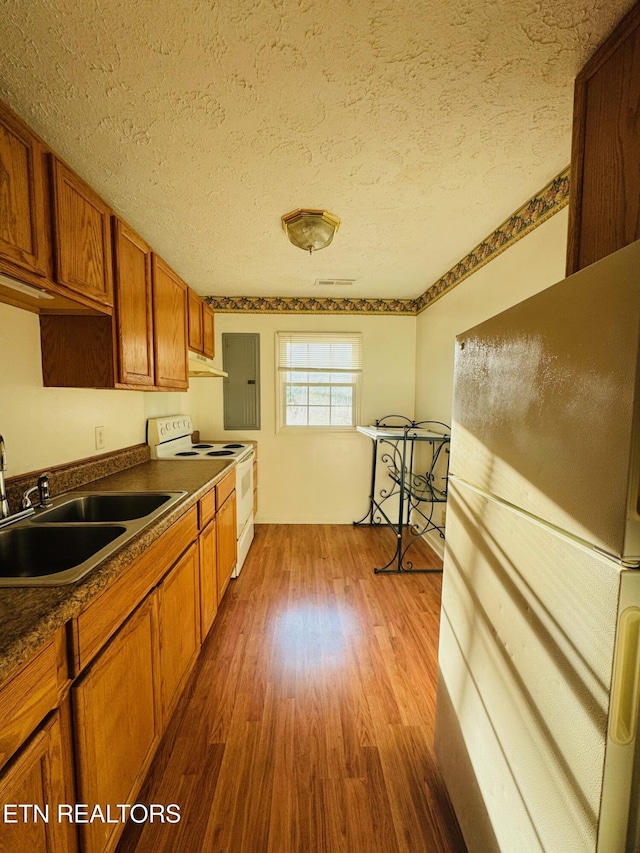 160 Clevenger Cut Off Rd, Newport, TN 37821 - kitchen featuring white appliances, dark countertops, brown cabinetry, a textured ceiling, and dark wood-style flooring