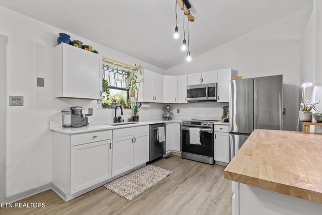 3123 Valemont Dr, Maryville, TN 37803 - kitchen featuring stainless steel appliances, light wood-type flooring, lofted ceiling, white cabinets, and pendant lighting