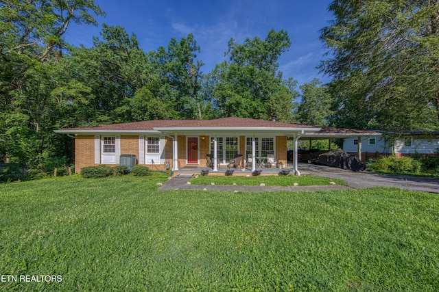 109 Wedgewood Rd, Oak Ridge, TN 37830 - view of front of home with asphalt driveway, a front yard, an attached carport, and brick siding