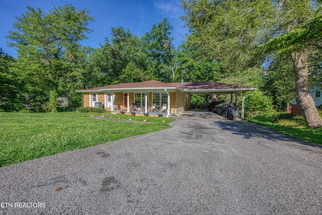 109 Wedgewood Rd, Oak Ridge, TN 37830 - ranch-style home with asphalt driveway, a porch, a front lawn, brick siding, and an attached carport