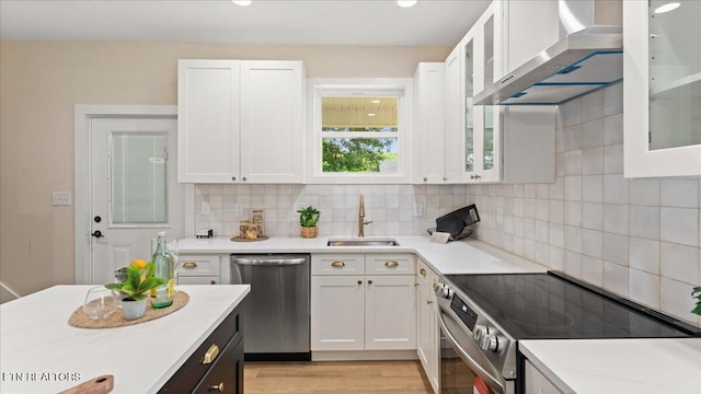 130 S Van Gilder St, Knoxville, TN 37915 - kitchen with stainless steel appliances, wall chimney exhaust hood, light countertops, and white cabinets