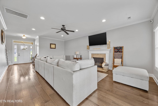 2679 Brooke Willow Blvd, Knoxville, TN 37932 - living area featuring recessed lighting, wood finished floors, a fireplace with flush hearth, a ceiling fan, and crown molding
