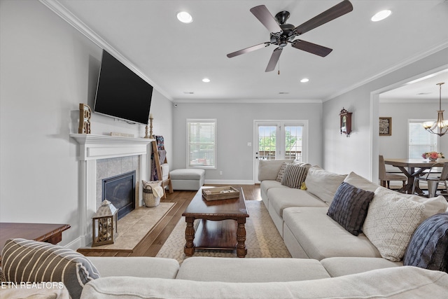 2679 Brooke Willow Blvd, Knoxville, TN 37932 - living room with wood finished floors, recessed lighting, a ceiling fan, a tile fireplace, and crown molding