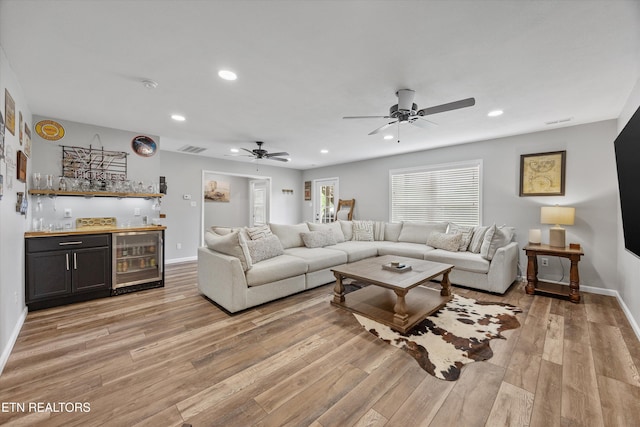2679 Brooke Willow Blvd, Knoxville, TN 37932 - living room featuring wine cooler, bar with sink, a ceiling fan, light wood finished floors, and recessed lighting
