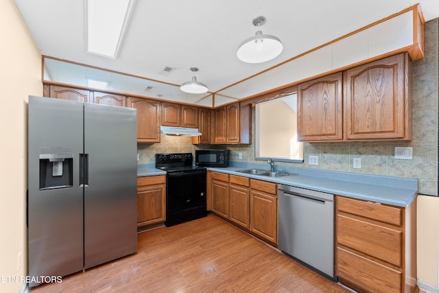 8016 Stablegate Way, Powell, TN 37849 - kitchen with black appliances, under cabinet range hood, light wood finished floors, backsplash, and light countertops
