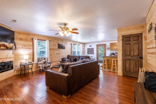 460 Red Bud Ln, Sevierville, TN 37876 - living area featuring wooden walls, dark wood-style flooring, and a ceiling fan