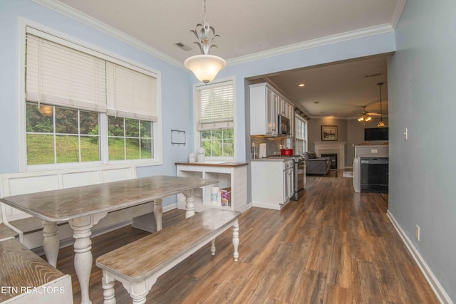 1223 Walnut Branch Ln, Knoxville, TN 37922 - dining space with crown molding, a fireplace, ceiling fan, and dark wood-type flooring