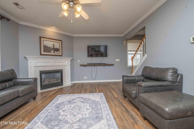 1223 Walnut Branch Ln, Knoxville, TN 37922 - living area featuring ceiling fan, stairs, wood finished floors, ornamental molding, and a tiled fireplace