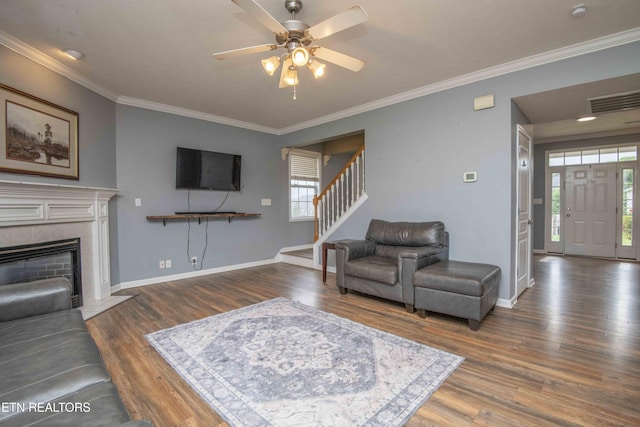 1223 Walnut Branch Ln, Knoxville, TN 37922 - living area with wood finished floors, a ceiling fan, stairway, ornamental molding, and a tile fireplace