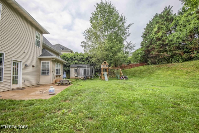 1223 Walnut Branch Ln, Knoxville, TN 37922 - view of yard featuring a storage unit, a playground, and a patio area