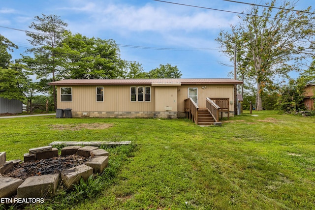 210 Conifer Rd, Winfield, TN 37892 - rear view of property featuring crawl space, a metal roof, a lawn, and a fire pit